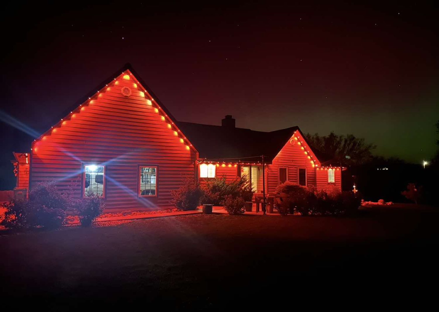 Ranch home washed entirely in red lighting