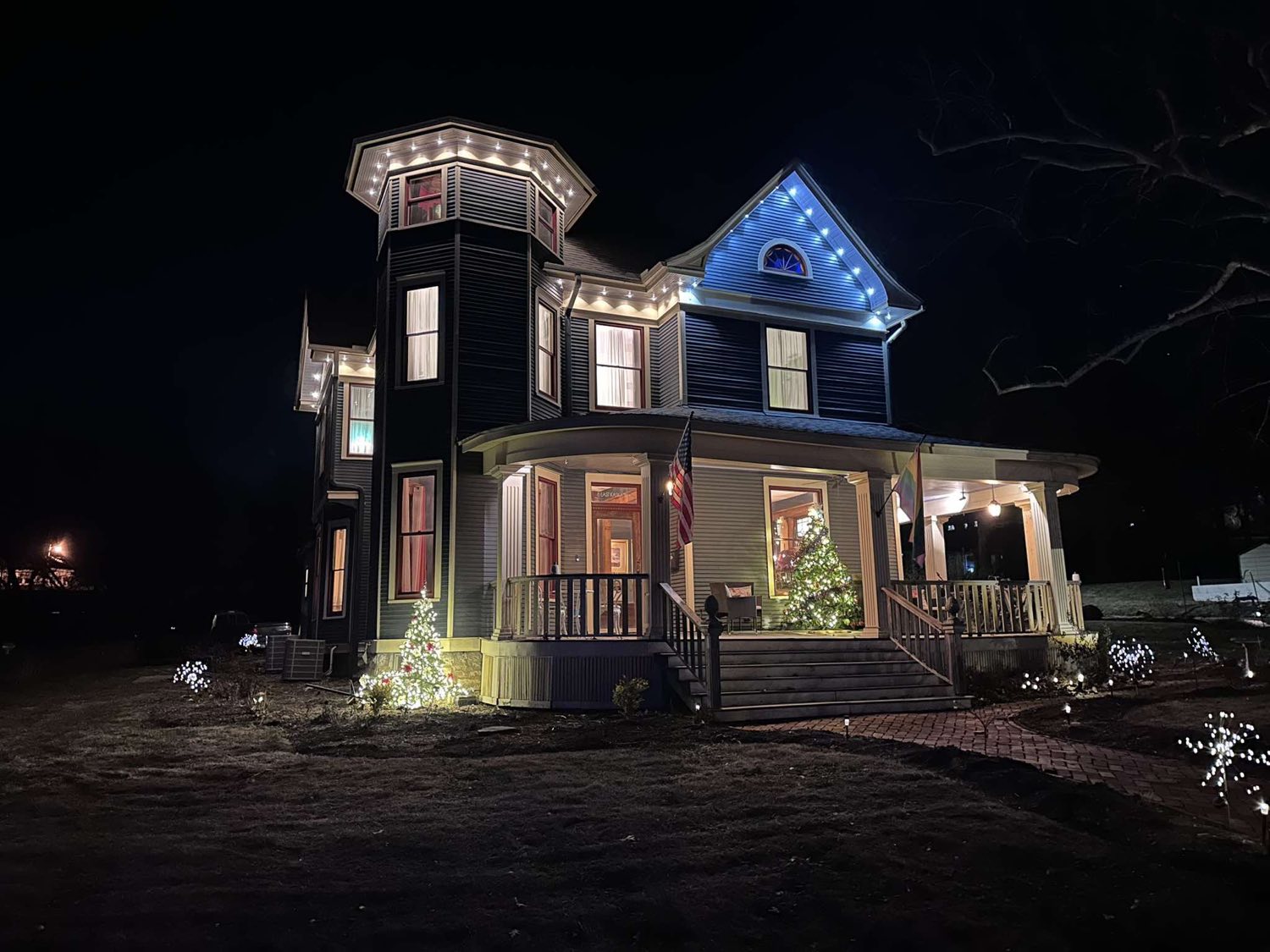 Victorian home outlined in Christmas lights